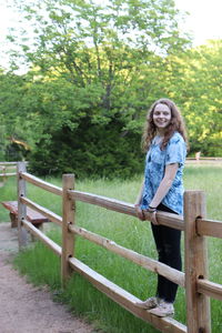 Portrait of smiling woman against trees