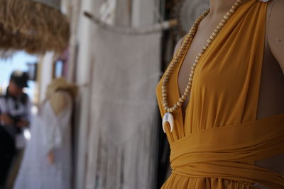 Close-up of yellow dress on mannequin