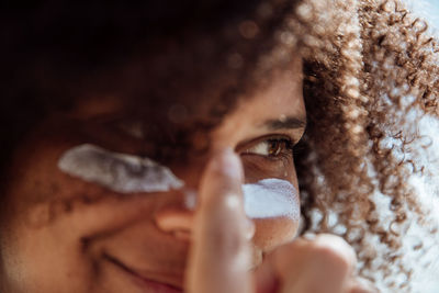 Woman applying sunscreen on the beach