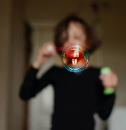 Close-up of a kid blowing soap bubbles 