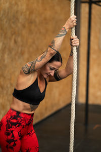 Midsection of woman holding rope