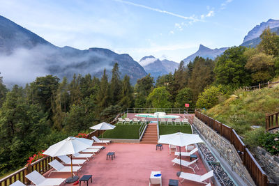 Scenic view of mountains and buildings against sky