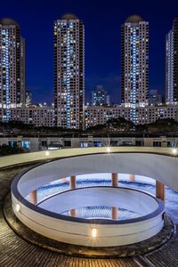 Illuminated modern buildings in city at night