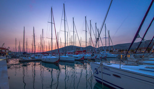 Boats in calm sea at sunset