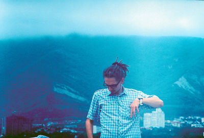 Young man standing in city