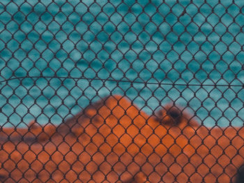 Full frame shot of chainlink fence with swimming pool