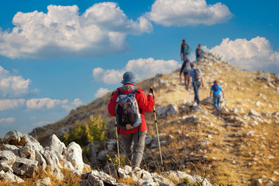 Group of hikers reach the top of the ridges of the mountains of pescasseroli, near the iorio refuge.