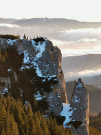 Rock formation on landscape against sky during sunset