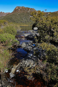 Scenic view of a creek against sky