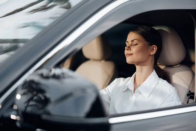 Portrait of smiling woman in car