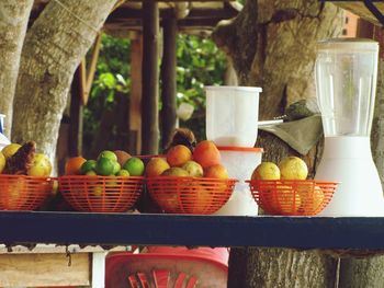 Various fruits in basket on table