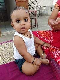 Cute baby girl sitting at home