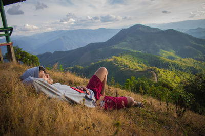 Scenic view of land and mountains against sky