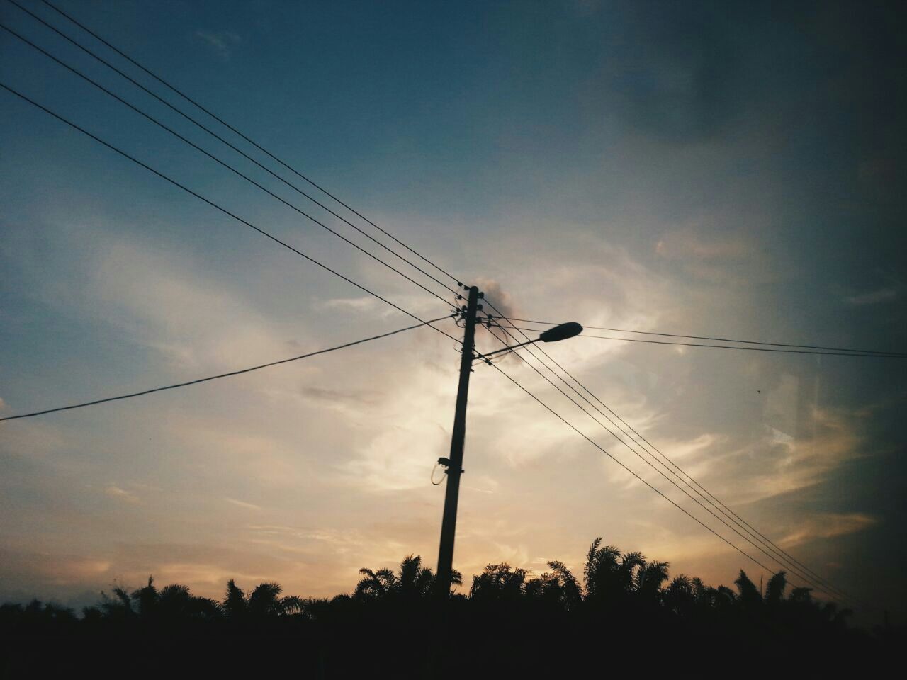 power line, electricity pylon, electricity, power supply, fuel and power generation, low angle view, silhouette, cable, connection, sky, technology, sunset, cloud - sky, cloud, dusk, power cable, tree, nature, cloudy, tranquility