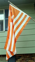 Low angle view of flag against built structure
