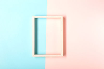 Picture frame design with shadow on pastel pink and blue background