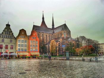 Buildings against cloudy sky