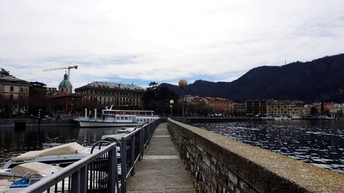 River amidst buildings in city against sky