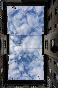 Low angle view of building against cloudy sky