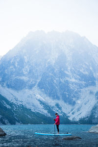 Rear view of man standing against mountain