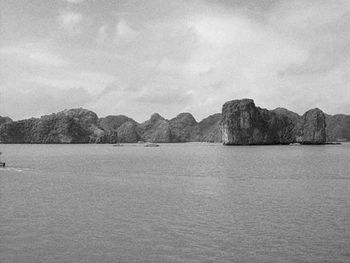 Scenic view of sea with mountain in background