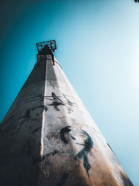 Low angle view of lighthouse against clear blue sky