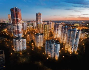 High angle view of illuminated buildings against sky at night