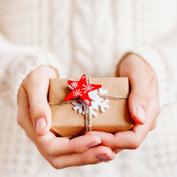 Cropped hand of woman holding gift