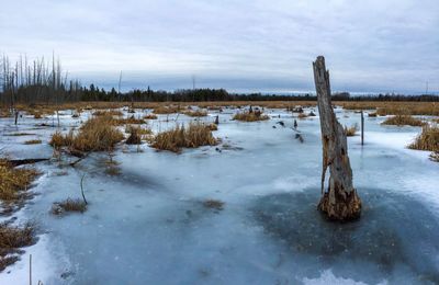 Scenic view of frozen lake against sky during winter