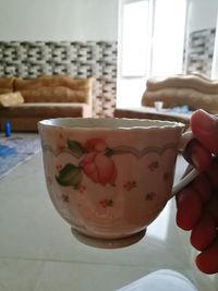 Close-up of hand holding drink at home