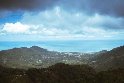 Scenic view of sea and mountains against sky
