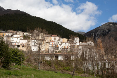 Buildings in town against sky