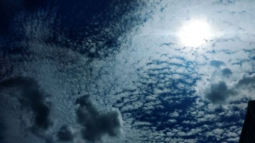 Low angle view of sun shining in sky