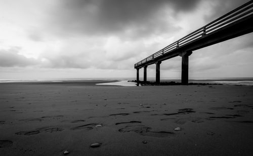 Lifeguard hut on beach against sky