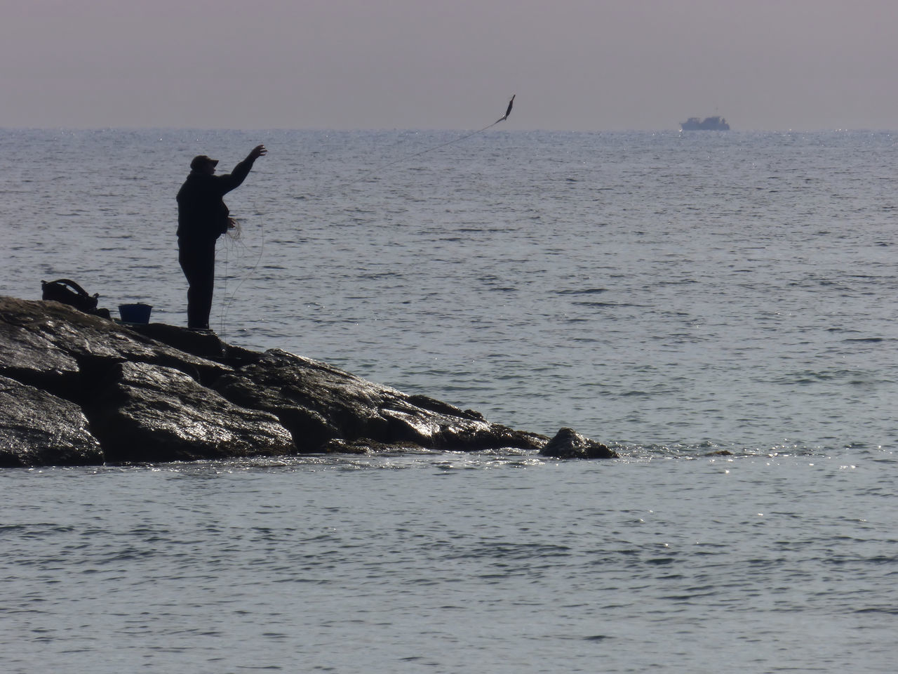 Fisherman throwing bait