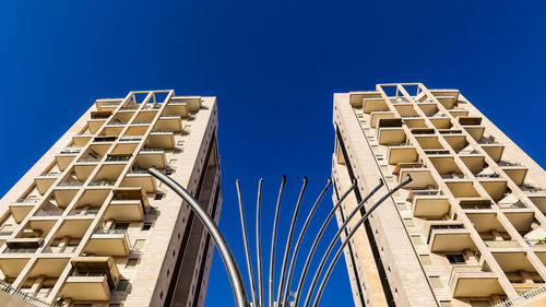 Low angle view of modern building against clear blue sky