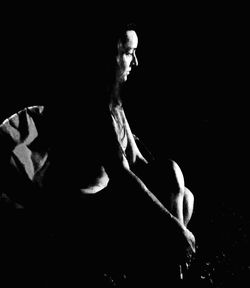 Close-up of hand over black background