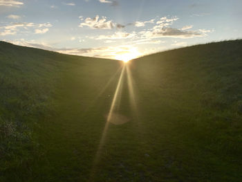 Scenic view of field against sky during sunset