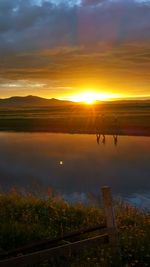 Scenic shot of calm lake at sunset