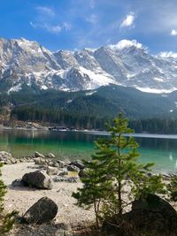 Scenic view of lake by mountains against sky