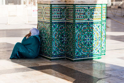 Low section of woman sitting on tiled floor