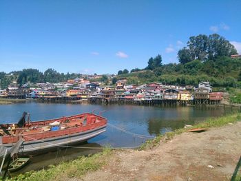 Boats moored in sea against clear sky