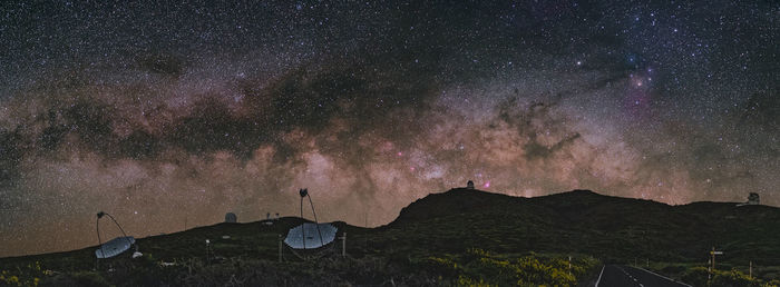 Scenic view of mountains against sky at night