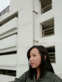 Beautiful woman standing against building