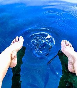 Low section of person swimming in pool