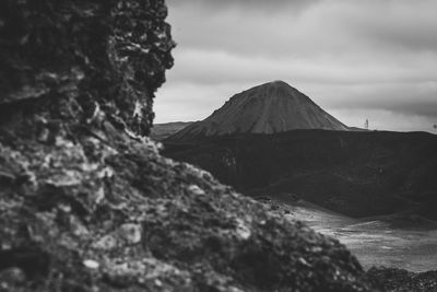 View of volcanic mountain against cloudy sky