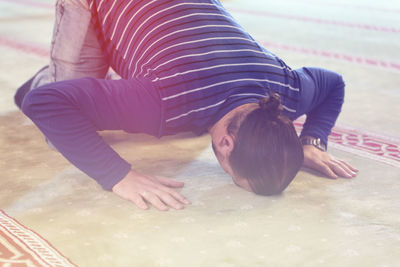 High angle view of woman lying on floor