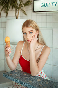 Portrait of young woman holding ice cream