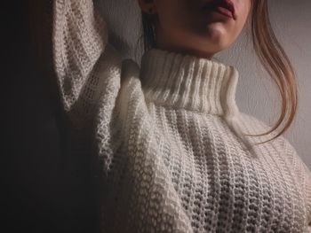 Close-up of woman with arms raised in background