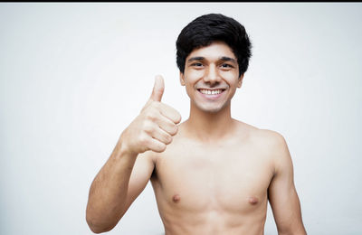 Portrait of a smiling young man against white background